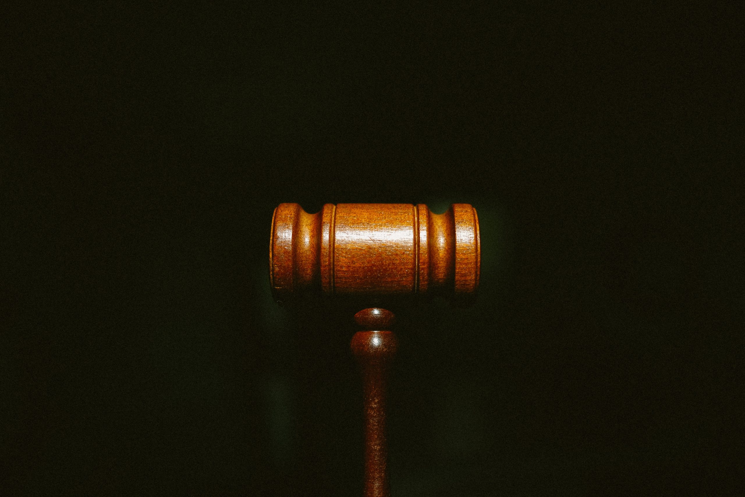 A gavel against a black background