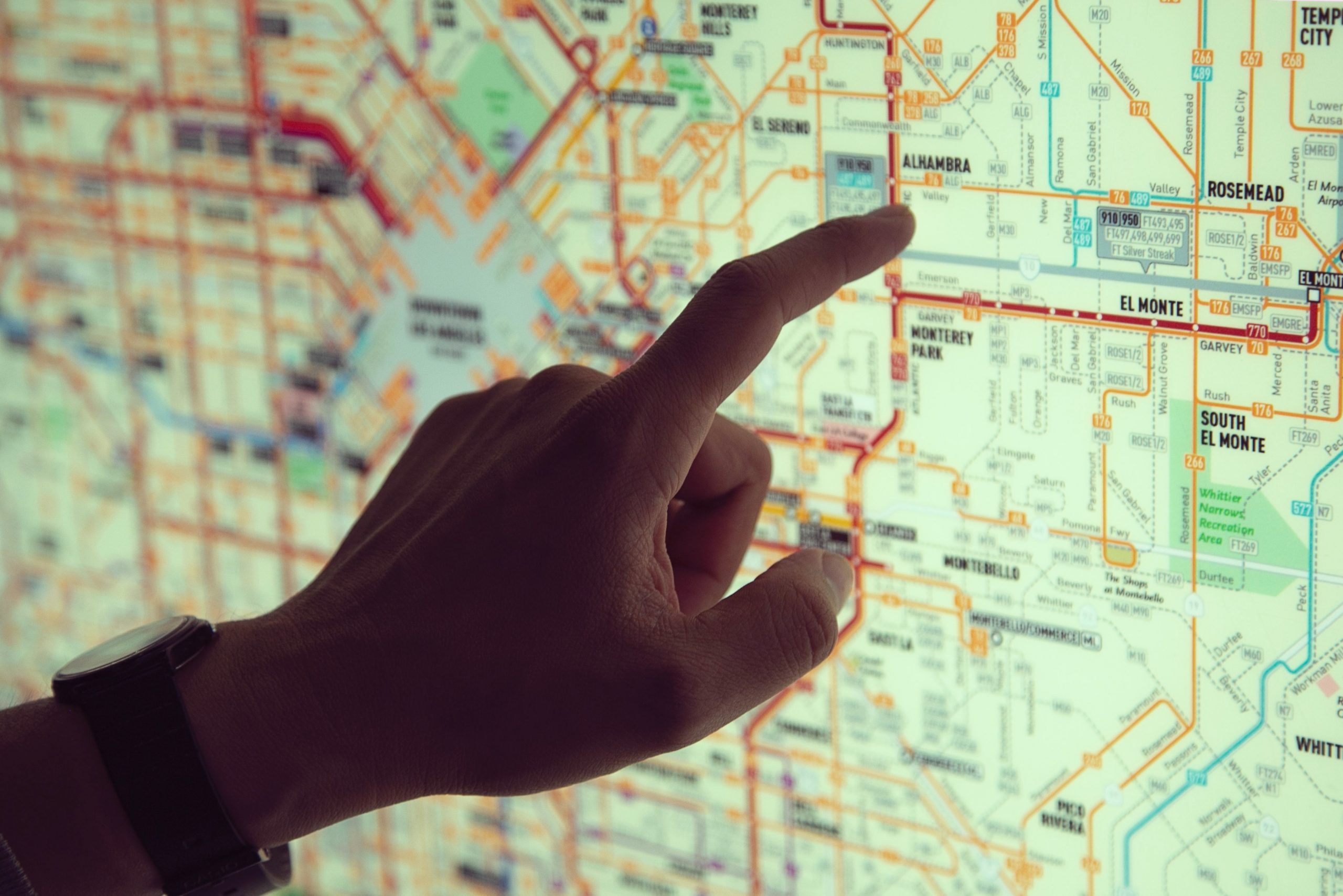 A finger pointing at a map of Los Angeles