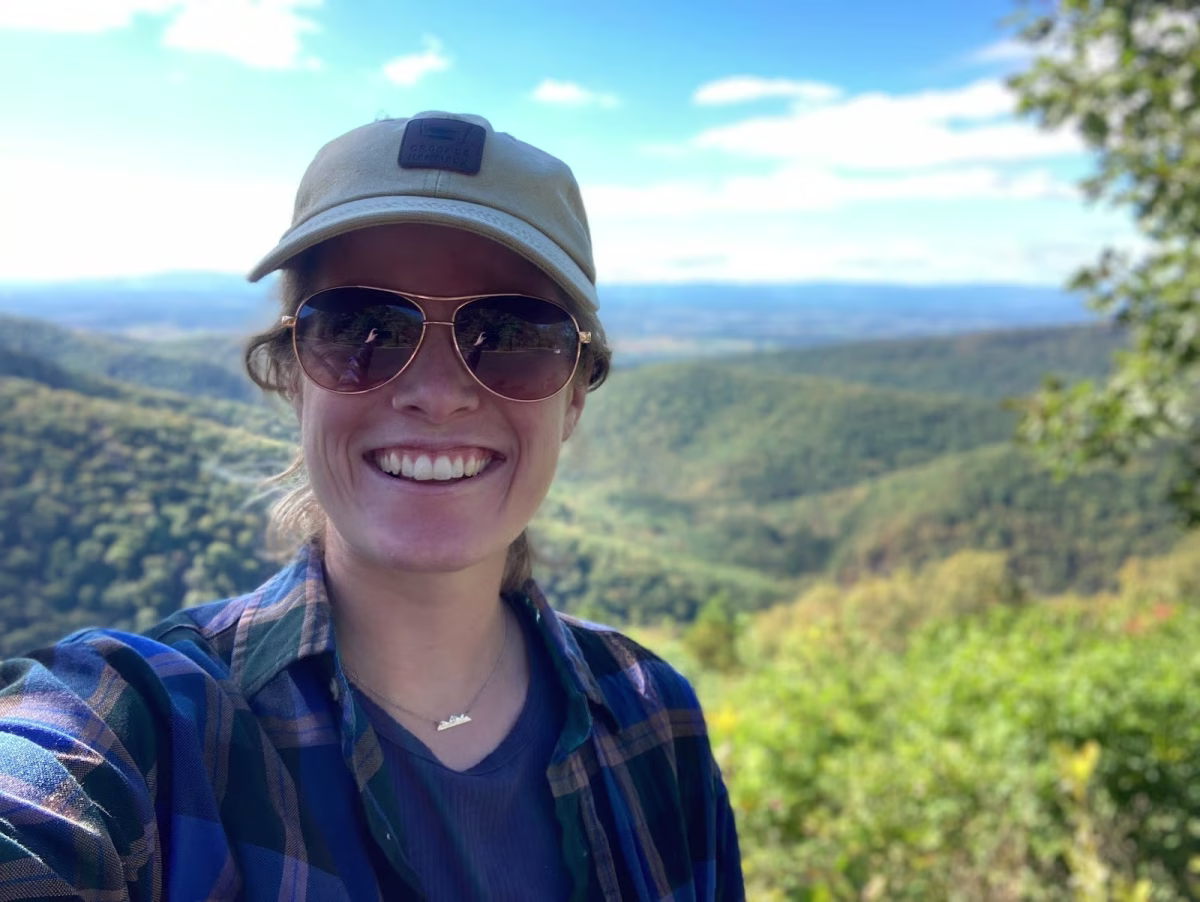 Emily Lytle wearing a hat and sunglasses in the mountains in Virginia